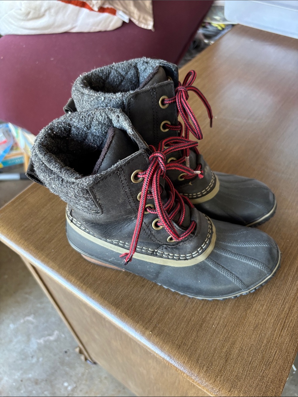 Black Sorel rain boots with red laces